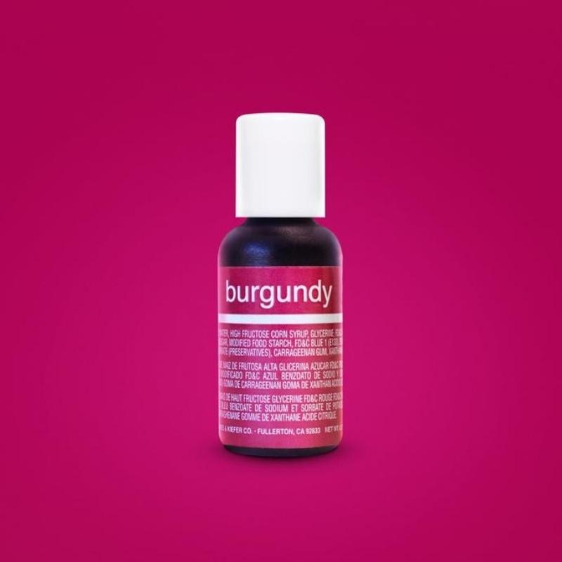 Bright burgundy background with small bottle of burgundy liquid food gel and white lid