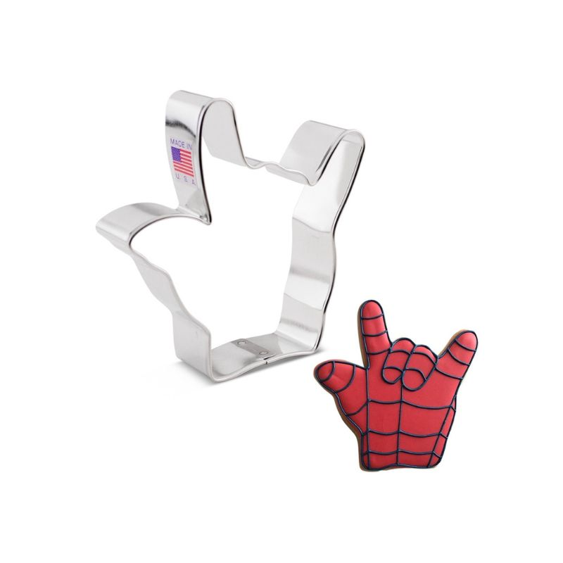 Metal cookie cutter made in the USA with flag stick on side in the shape of Spiderman hand with a cookie decorated with royal icing in red with black details