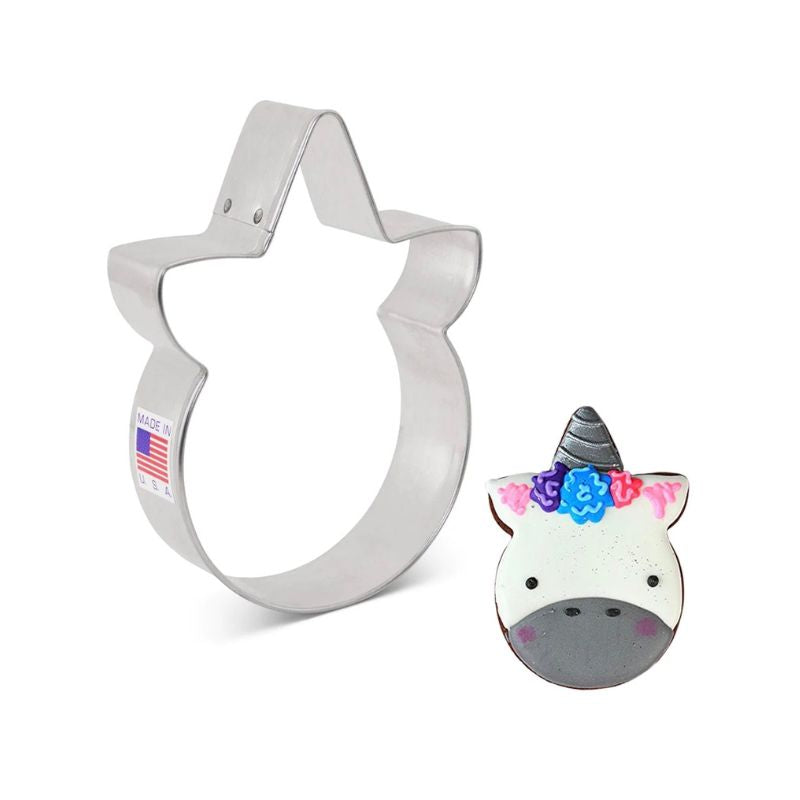 front facing unicorn cookie cutter made of stainless steel and unicorn cookie with flowers and silver 