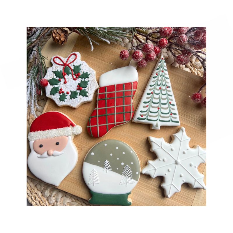 Christmas cookies on wood board with Santa and snowflake and sugared holly