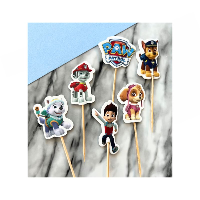 5 different paw patrol characters and one paw patrol sign with sticks for cupcakes