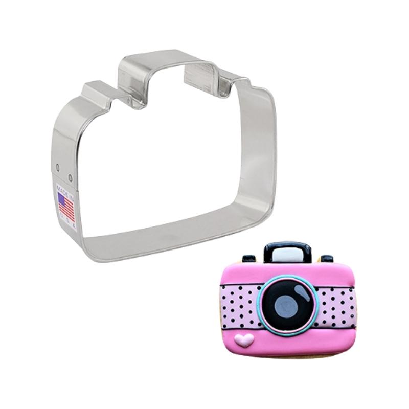 Camera cookie cutter for decorated camera cookies that are pink with black accents for birthday parties or favours