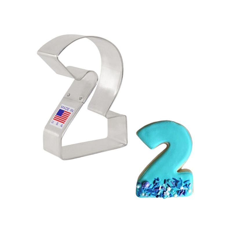 Stainless steel number 2 cookie cutter made in the usa with flag sticker and cookie decorated beside with teal icing and sprinkles