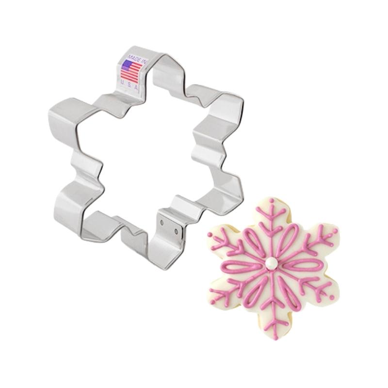 Winter geo snow flake cookie cutter made in the USA and decorated with royal icing and details in pink