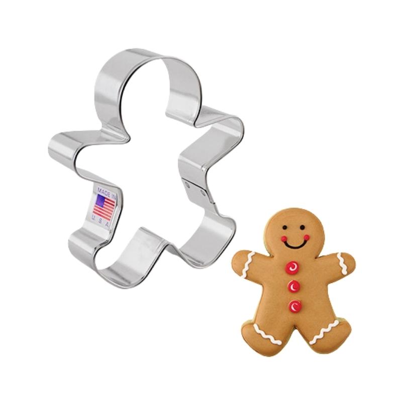 Metal cookie cutter made in the USA and of metal and gingerbread boy decorated cookie with icing and red buttons