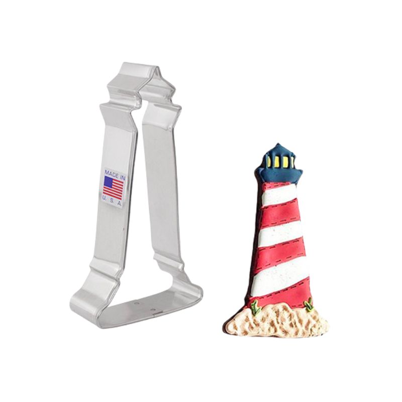 Cookie cutter in the shape of a light house metal and made in the USA with a cookie beside with red and white stripe icing with black tower 