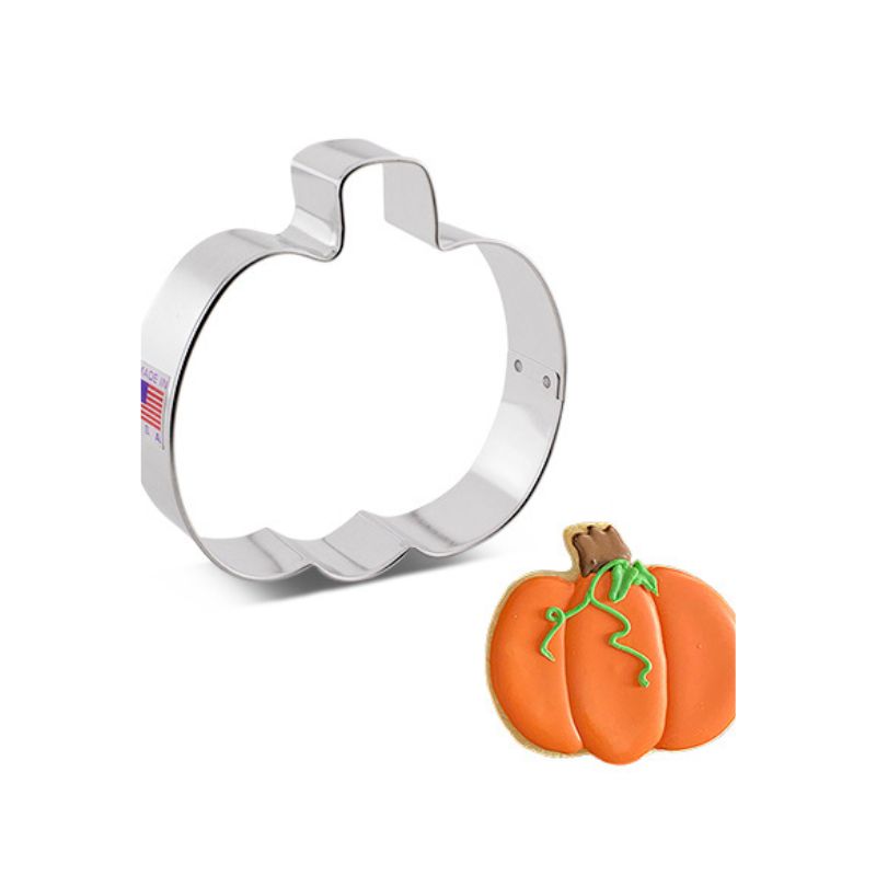 Mini metal pumpkin cookie cutter made in the USA and mini pumpkin cookie decorated in Orange icing and green and brown details