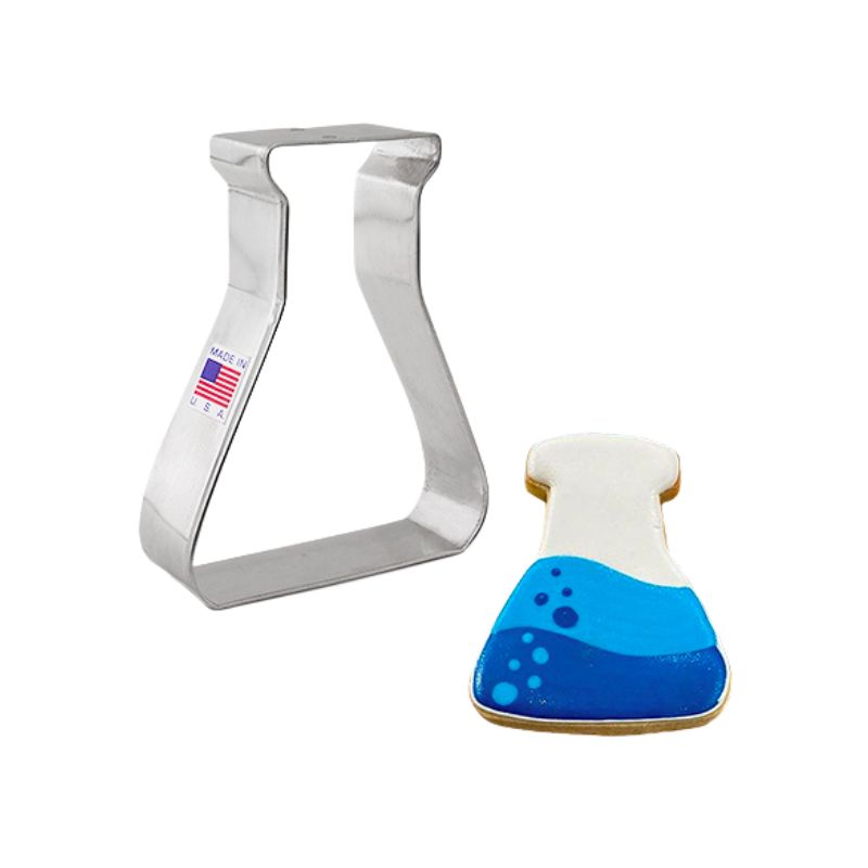 Science beaker metal cookie cutter with made in the usa American flag sticker and beside different shades of blue and white decorated sugar cookie