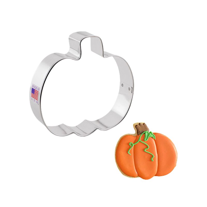 Metal cookie cutter in the shape of a pumpkin size small with a decorated pumpkin beside with orange brown and green icing