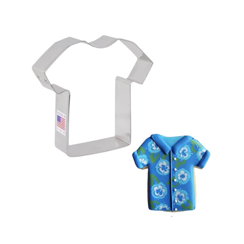 Metal t-shirt cookie cutter made in the USA with American flag and decorated sugar cookie with blue background and white flowers and green leaves