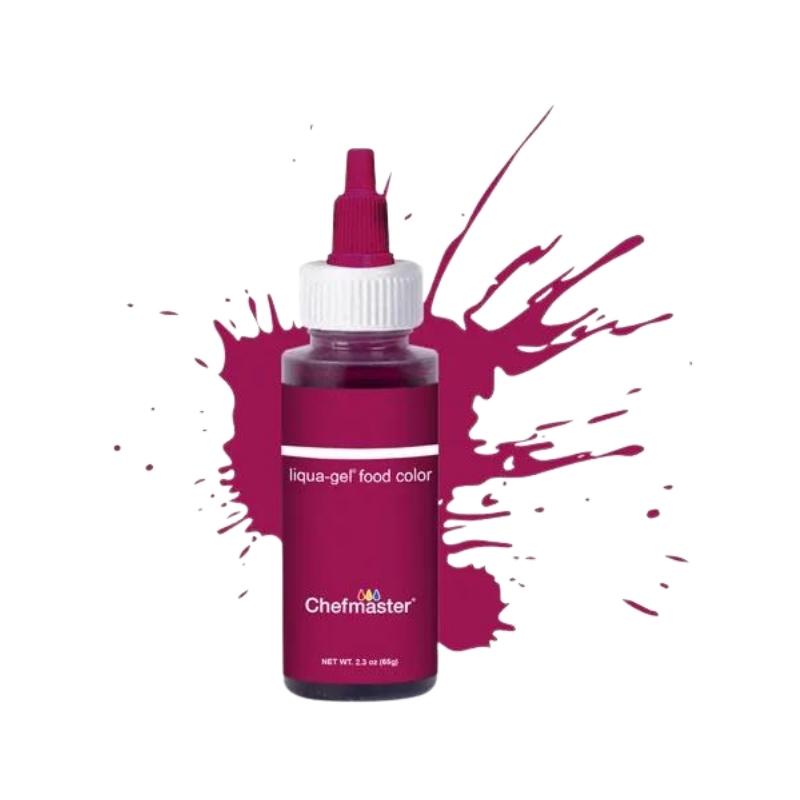 Burgundy paint splatter background with bottle of Burgundy bottle of food coloring